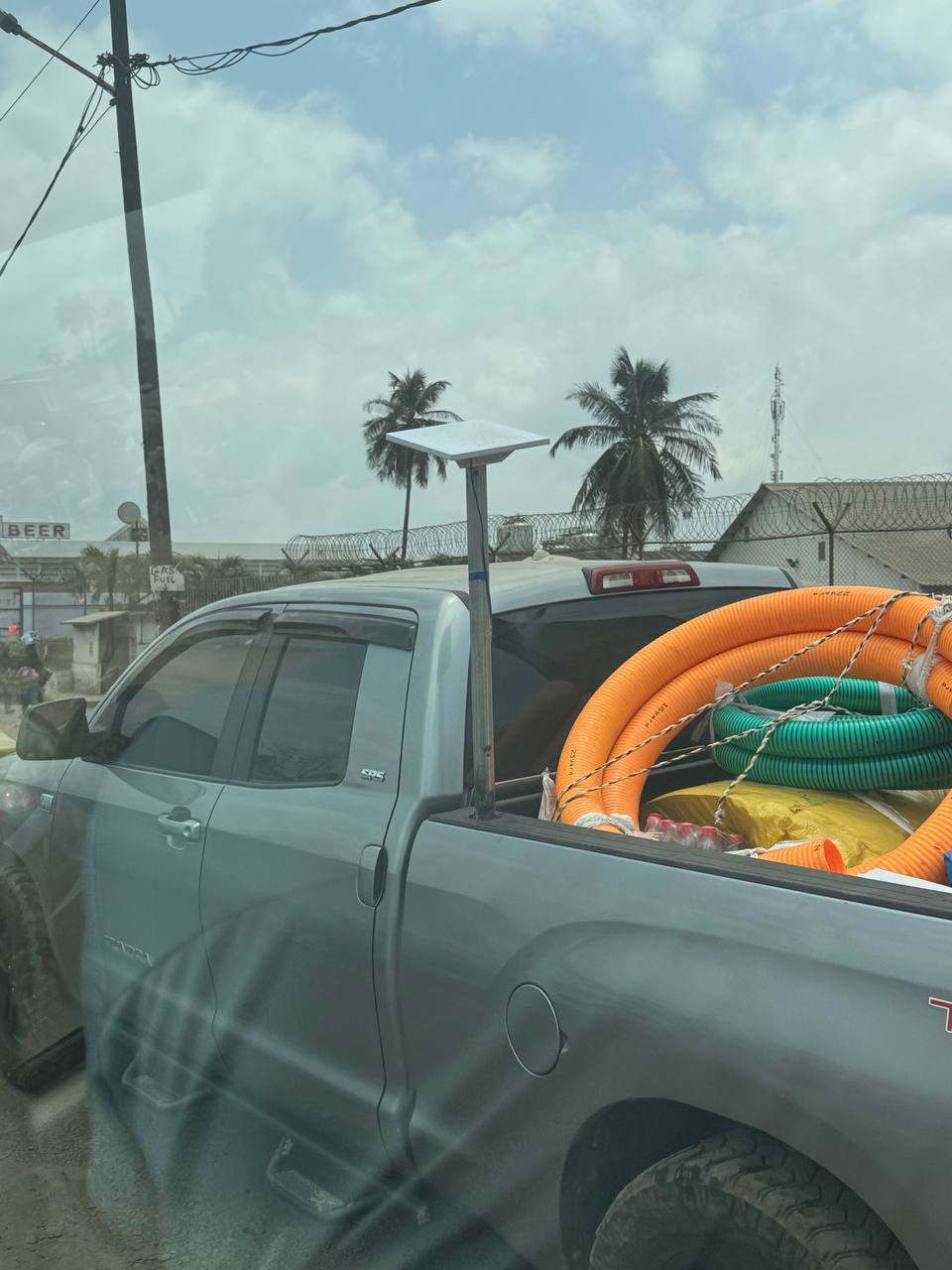 A Starlink terminal rigged to a pole in a truck on a Monrovia street